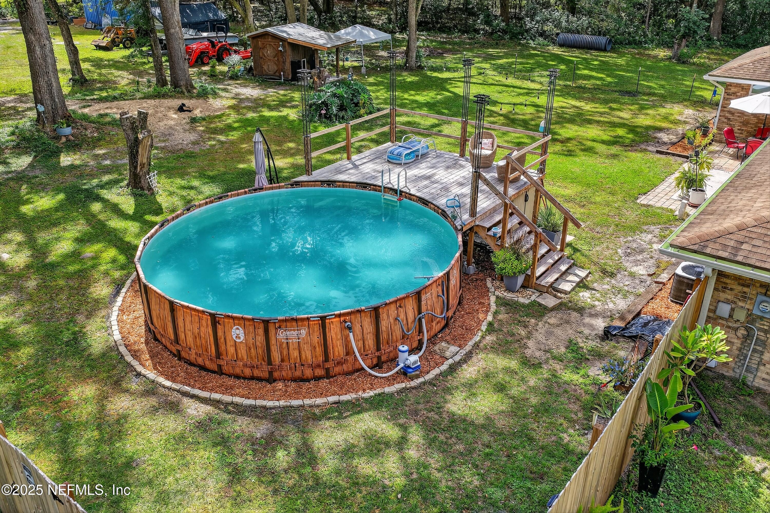 6049 Taylor Road Jacksonville, FL 32234 - Photo 48 of 60 a view of a swimming pool with a yard and sitting area