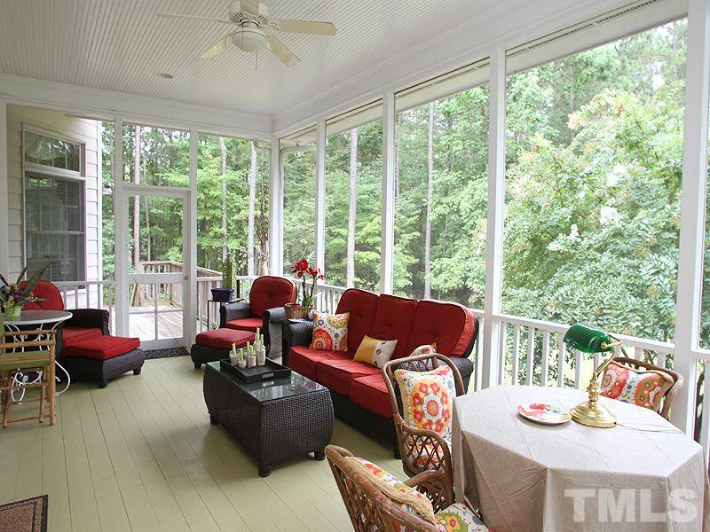 1206 Stanridge Drive Raleigh, NC 27613 - Photo 22 of 25 a living room with furniture and floor to ceiling windows