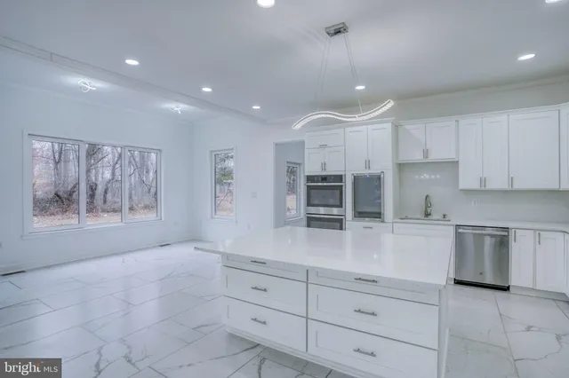 a kitchen with a refrigerator sink and stainless steel appliances