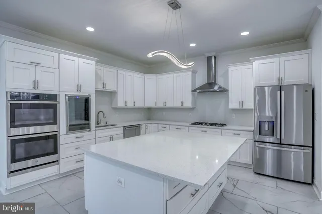a view of a hallway with kitchen and dining area chandelier