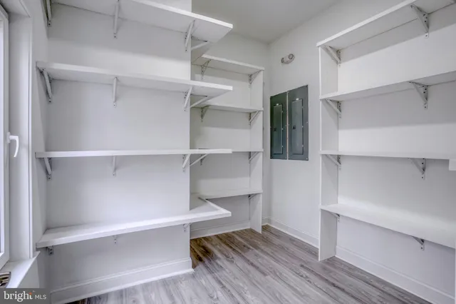 an empty room with windows and closet