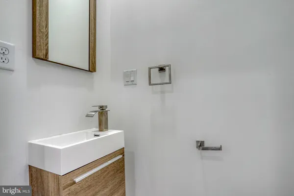 a bathroom with a toilet sink vanity tub and shower