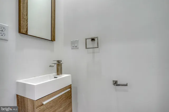 a bathroom with a toilet sink vanity tub and shower