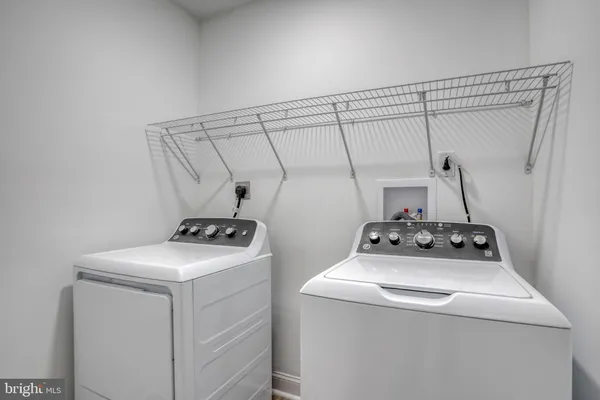 a spacious bathroom with a double vanity sink a large mirror and a bathtub
