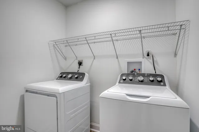 a spacious bathroom with a double vanity sink a large mirror and a bathtub