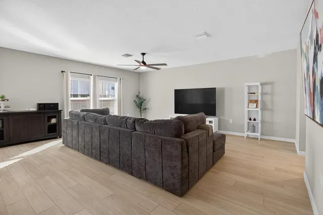 a kitchen with stainless steel appliances a dining table chairs microwave and sink