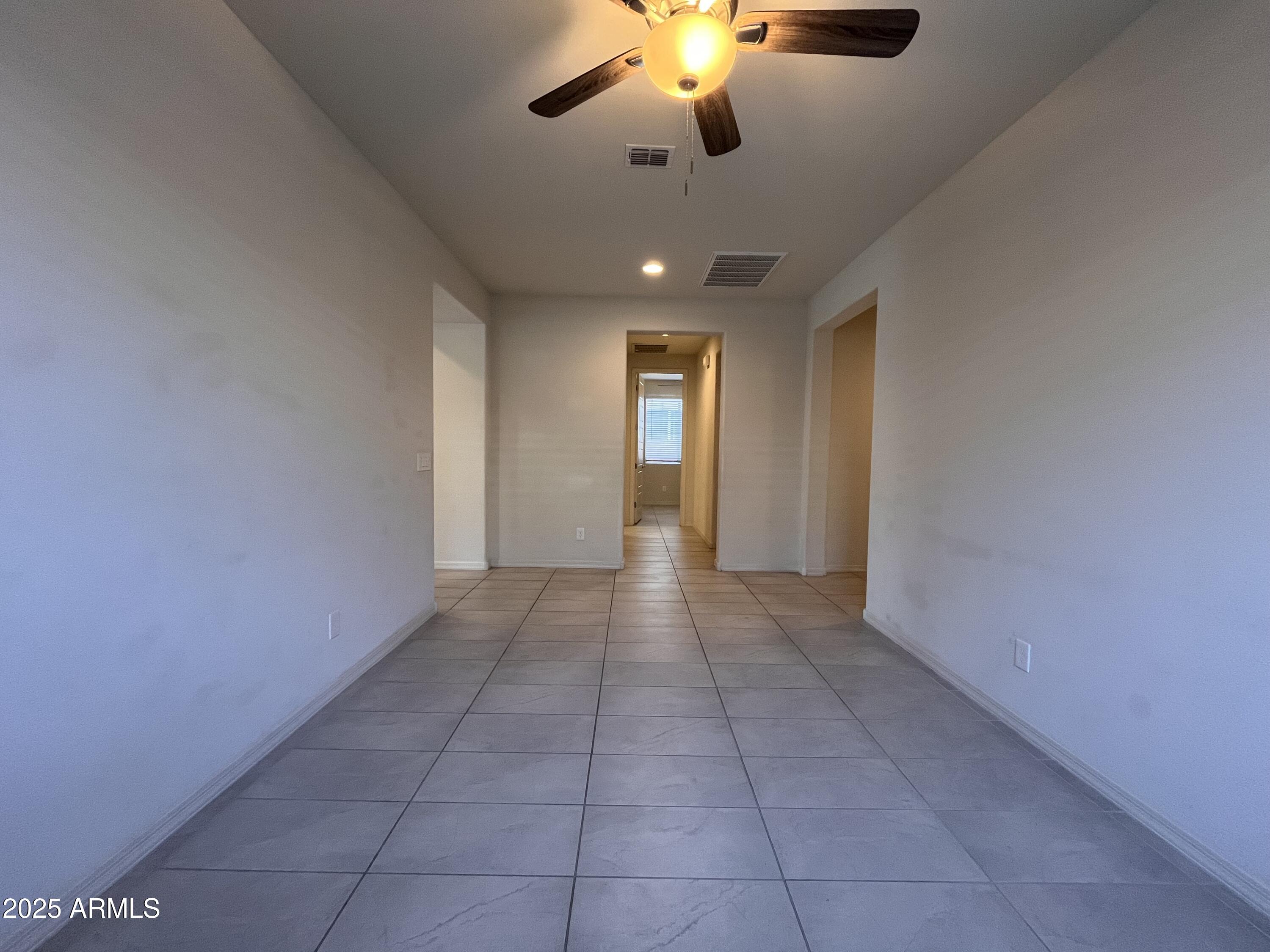 22857 East Marsh Road Queen Creek, AZ 85142 - Photo 12 of 38 a view of an empty room with a chandelier fan