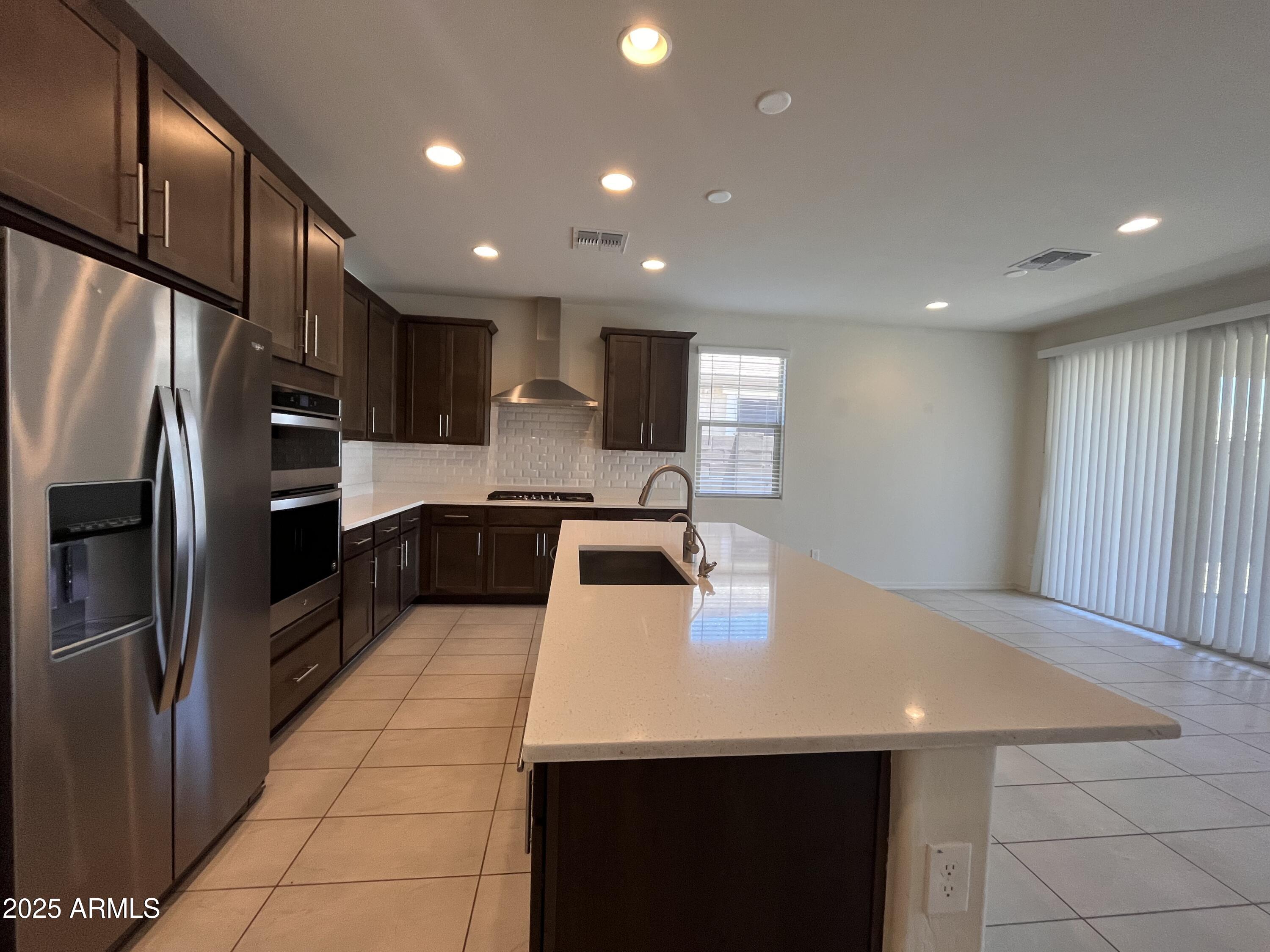 22857 East Marsh Road Queen Creek, AZ 85142 - Photo 13 of 38 a kitchen with stainless steel appliances a refrigerator sink and stove
