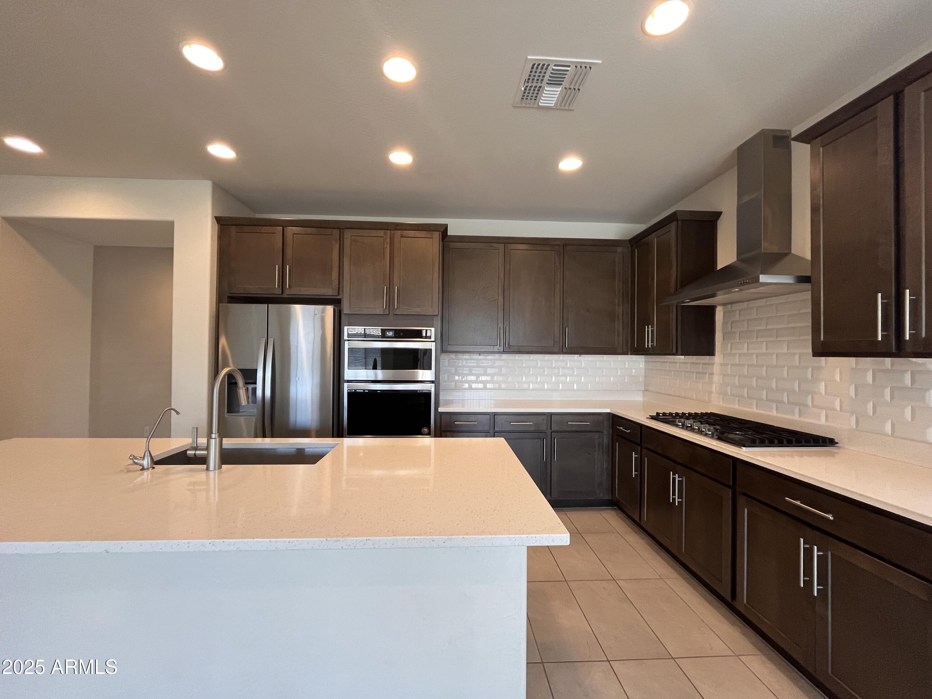22857 East Marsh Road Queen Creek, AZ 85142 - Photo 14 of 38 a large kitchen with cabinets