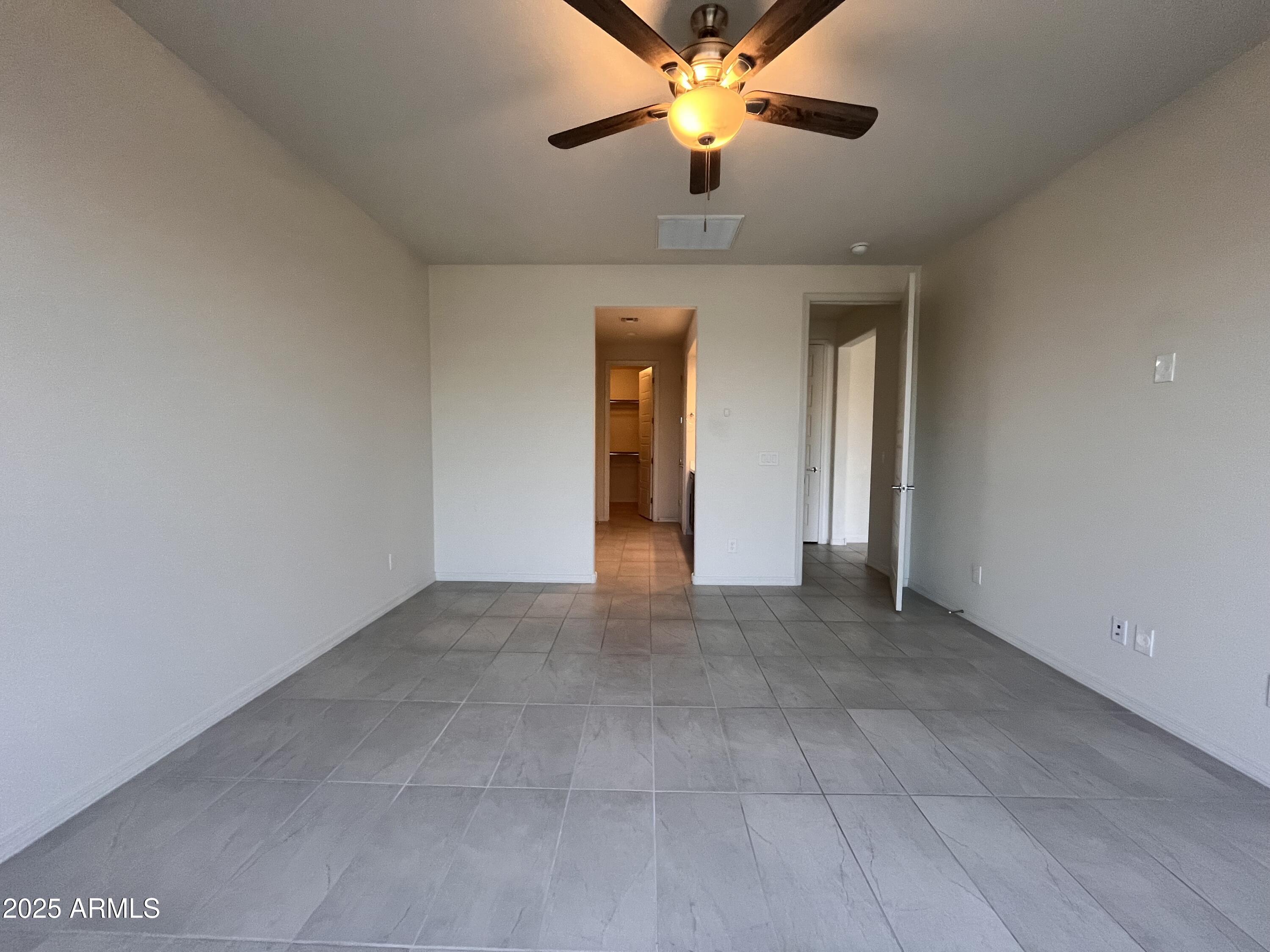 22857 East Marsh Road Queen Creek, AZ 85142 - Photo 24 of 38 a view of an empty room with a chandelier fan