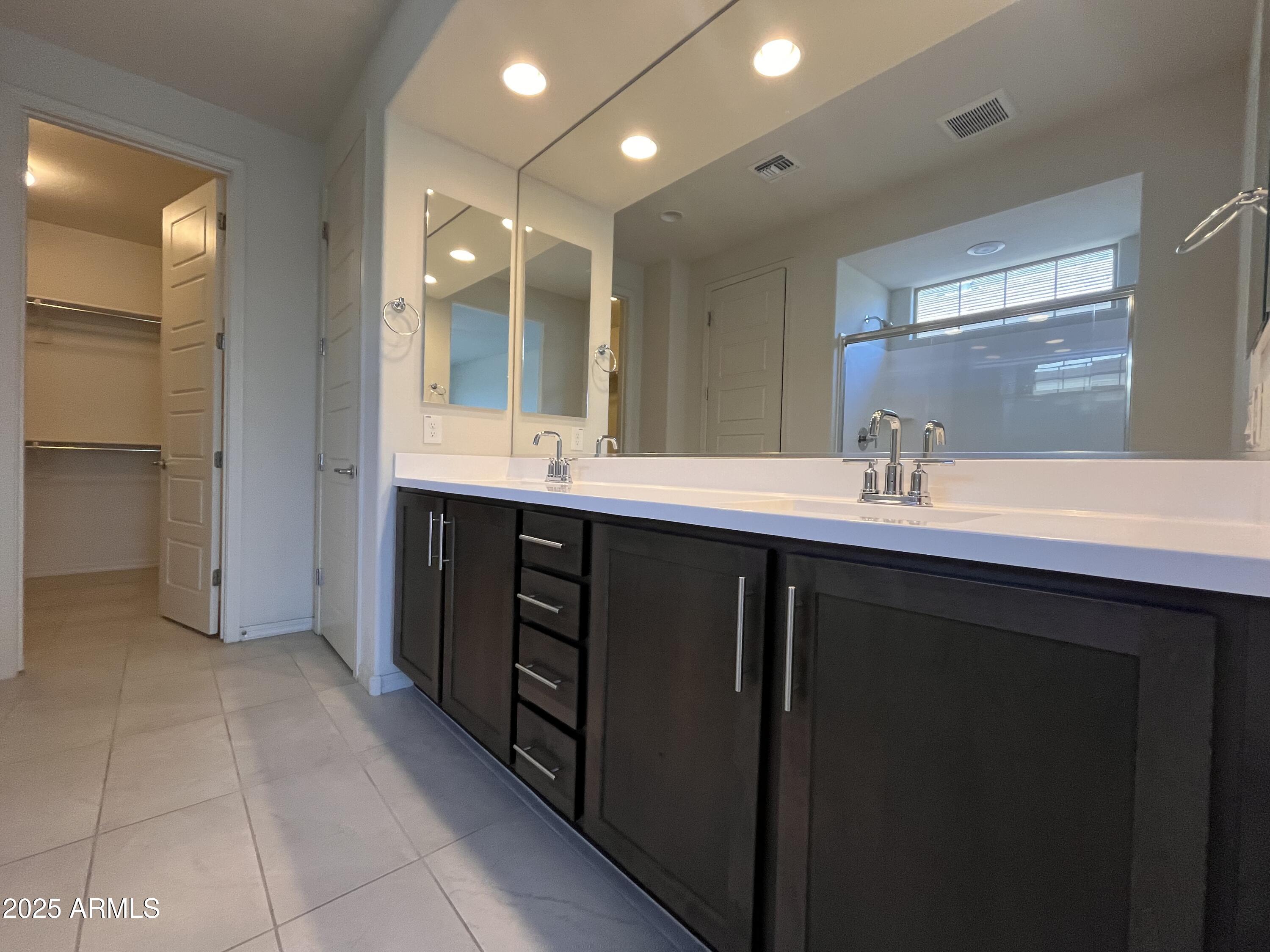 22857 East Marsh Road Queen Creek, AZ 85142 - Photo 25 of 38 a bathroom with a double vanity sink a mirror and a