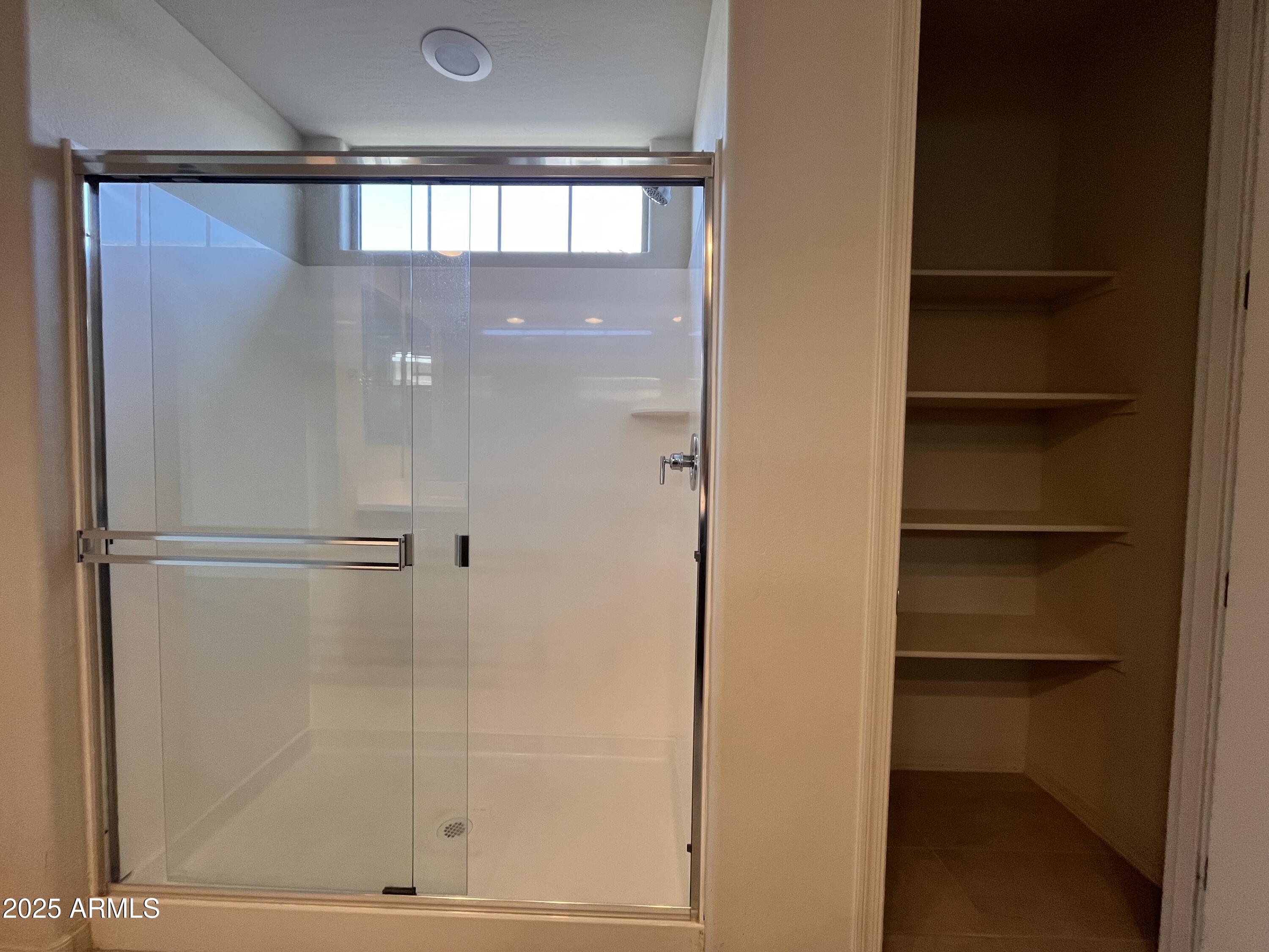 22857 East Marsh Road Queen Creek, AZ 85142 - Photo 27 of 38 a bathroom with a glass shower door