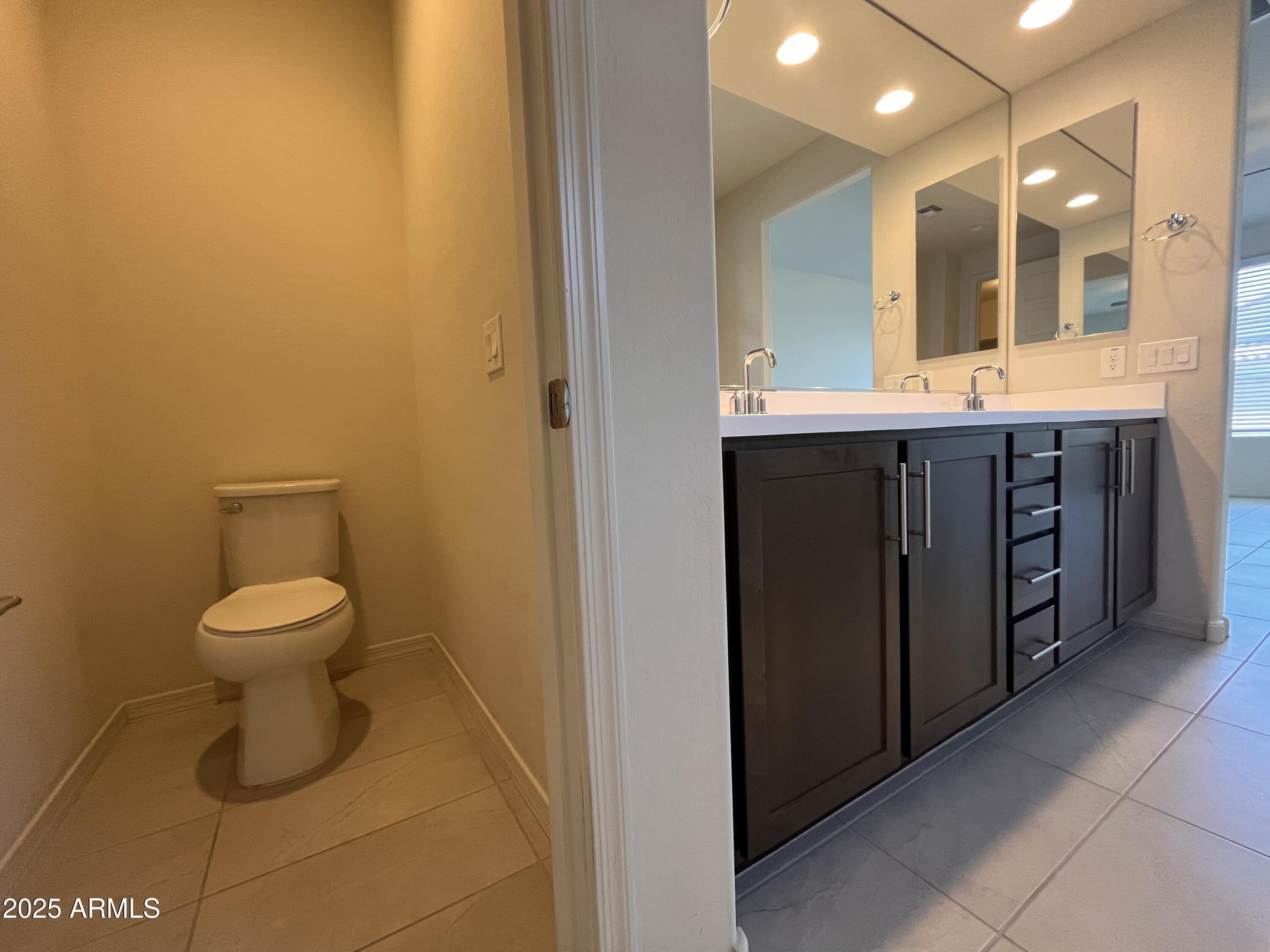 22857 East Marsh Road Queen Creek, AZ 85142 - Photo 28 of 38 a bathroom with a toilet sink and mirror