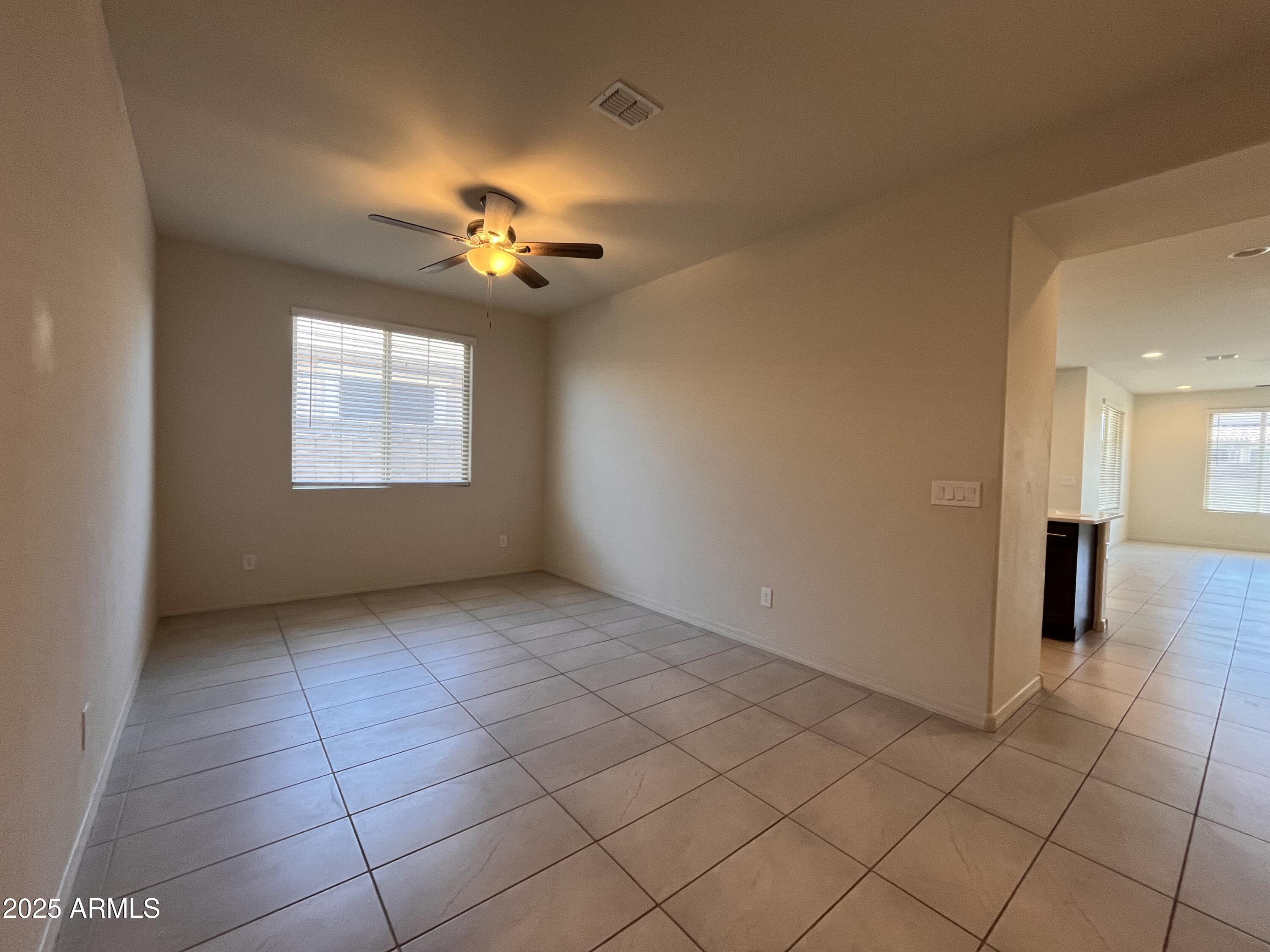22857 East Marsh Road Queen Creek, AZ 85142 - Photo 10 of 38 a view of a livingroom with a chandelier fan and windows
