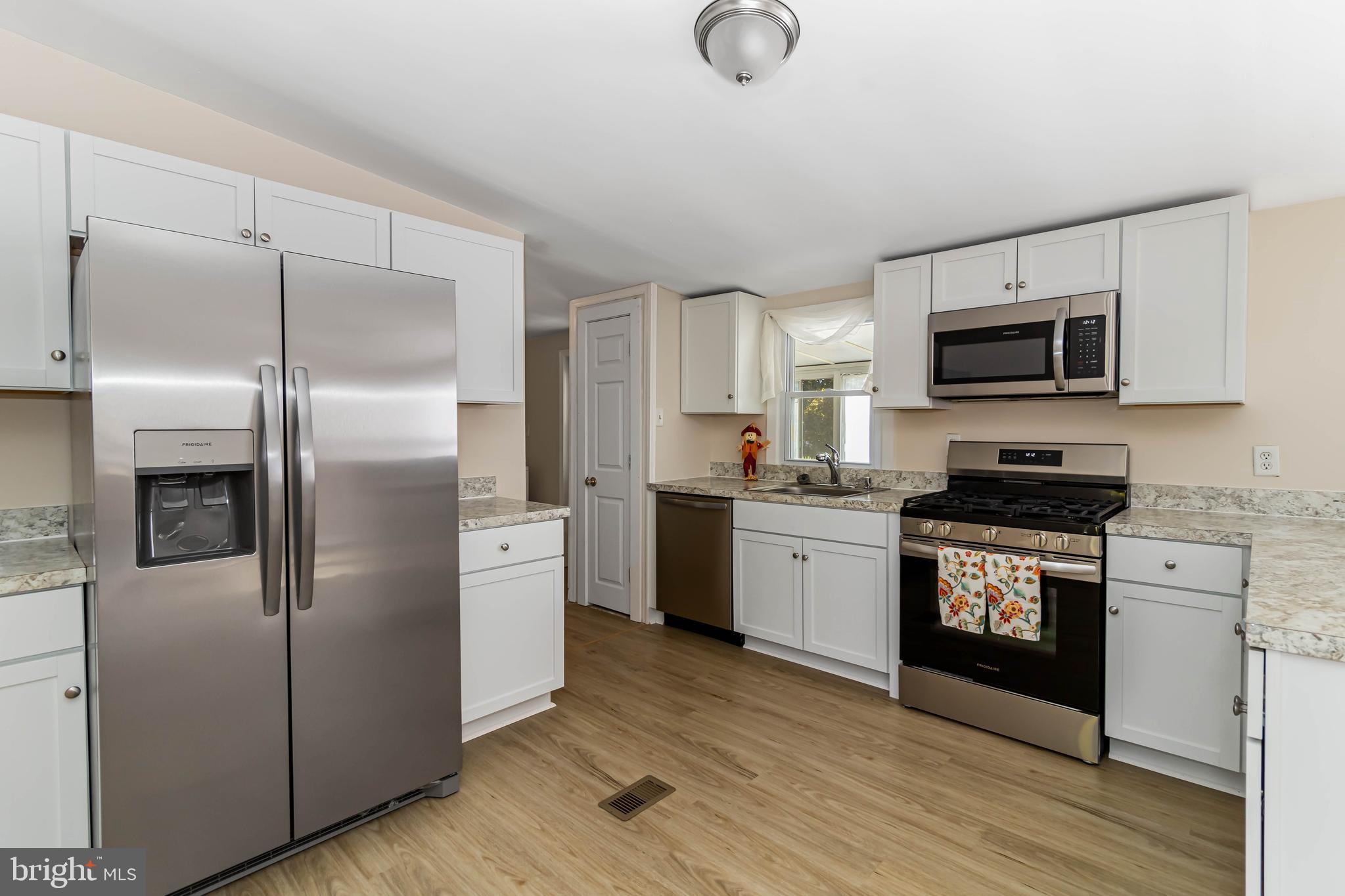 24 Welch Drive Dover, DE 19901 - Photo 7 of 39 a kitchen with a refrigerator stove and microwave