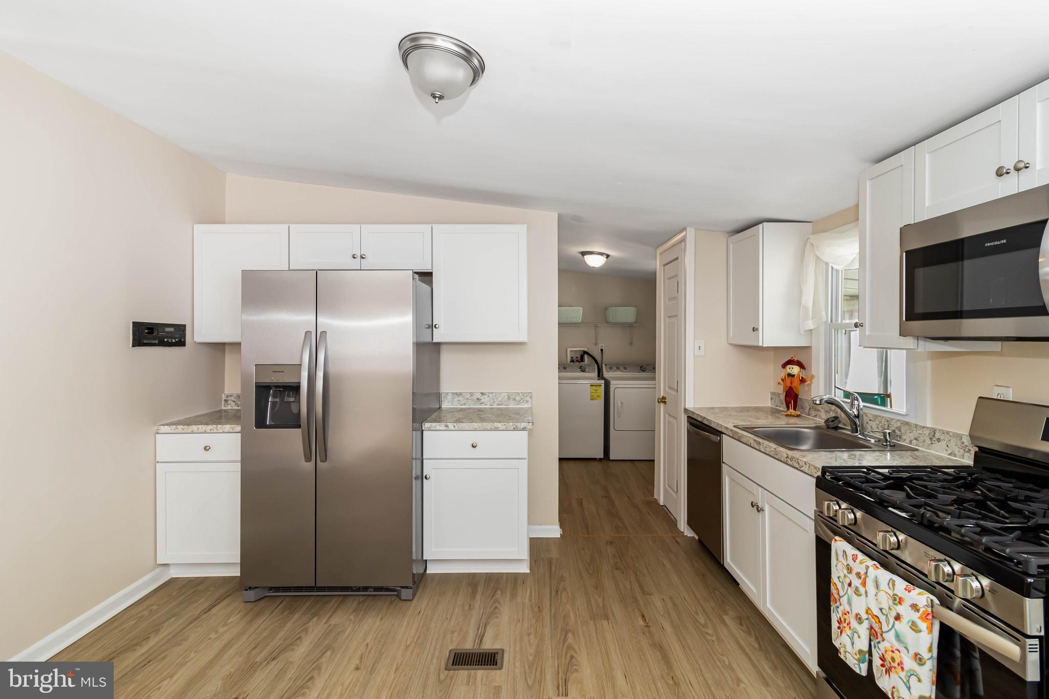 24 Welch Drive Dover, DE 19901 - Photo 8 of 39 a kitchen with a stove a refrigerator and a sink