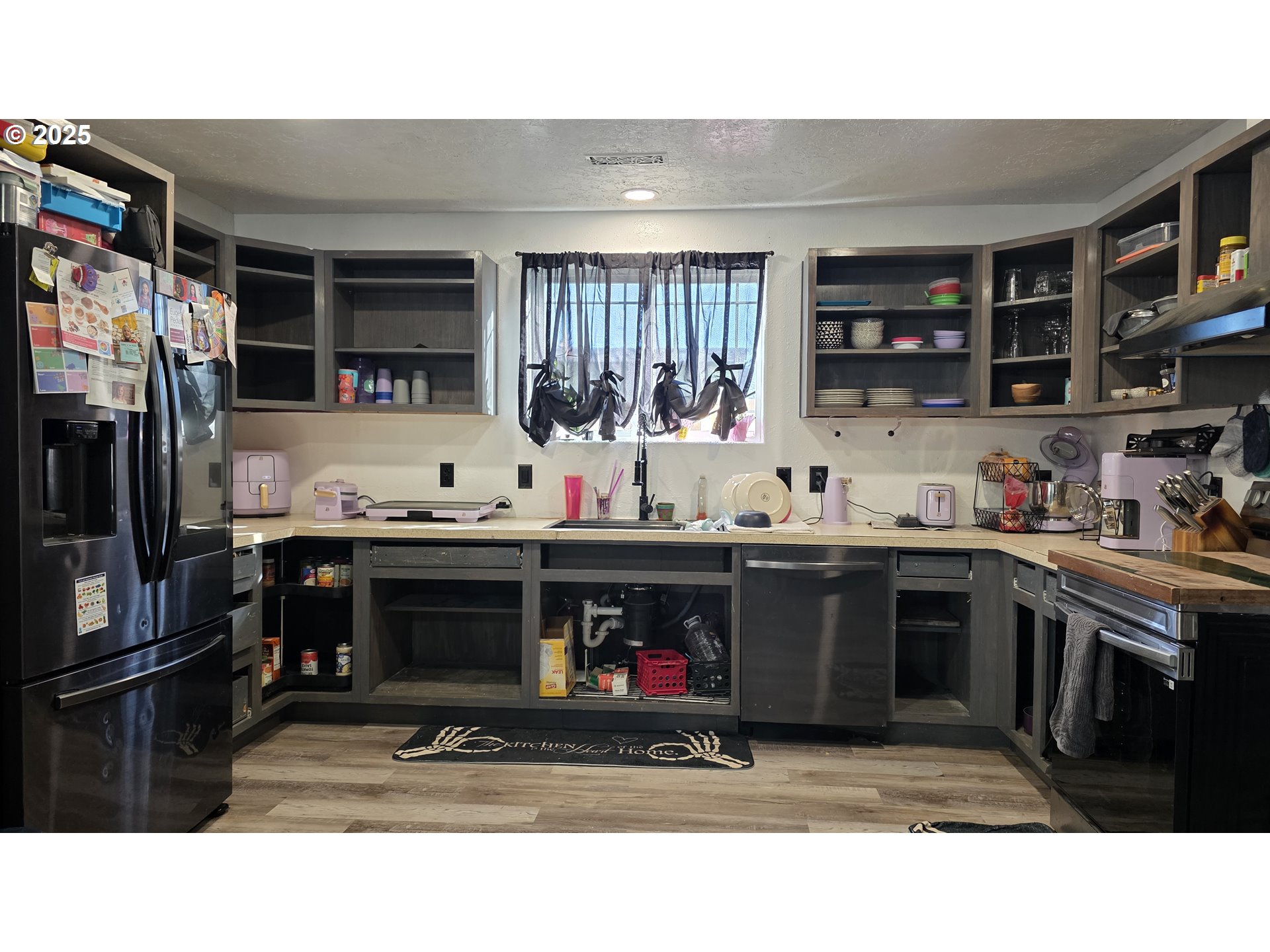 676 58th Street Springfield, OR 97478 - Photo 11 of 30 a kitchen with stainless steel appliances kitchen island granite countertop a refrigerator and a stove