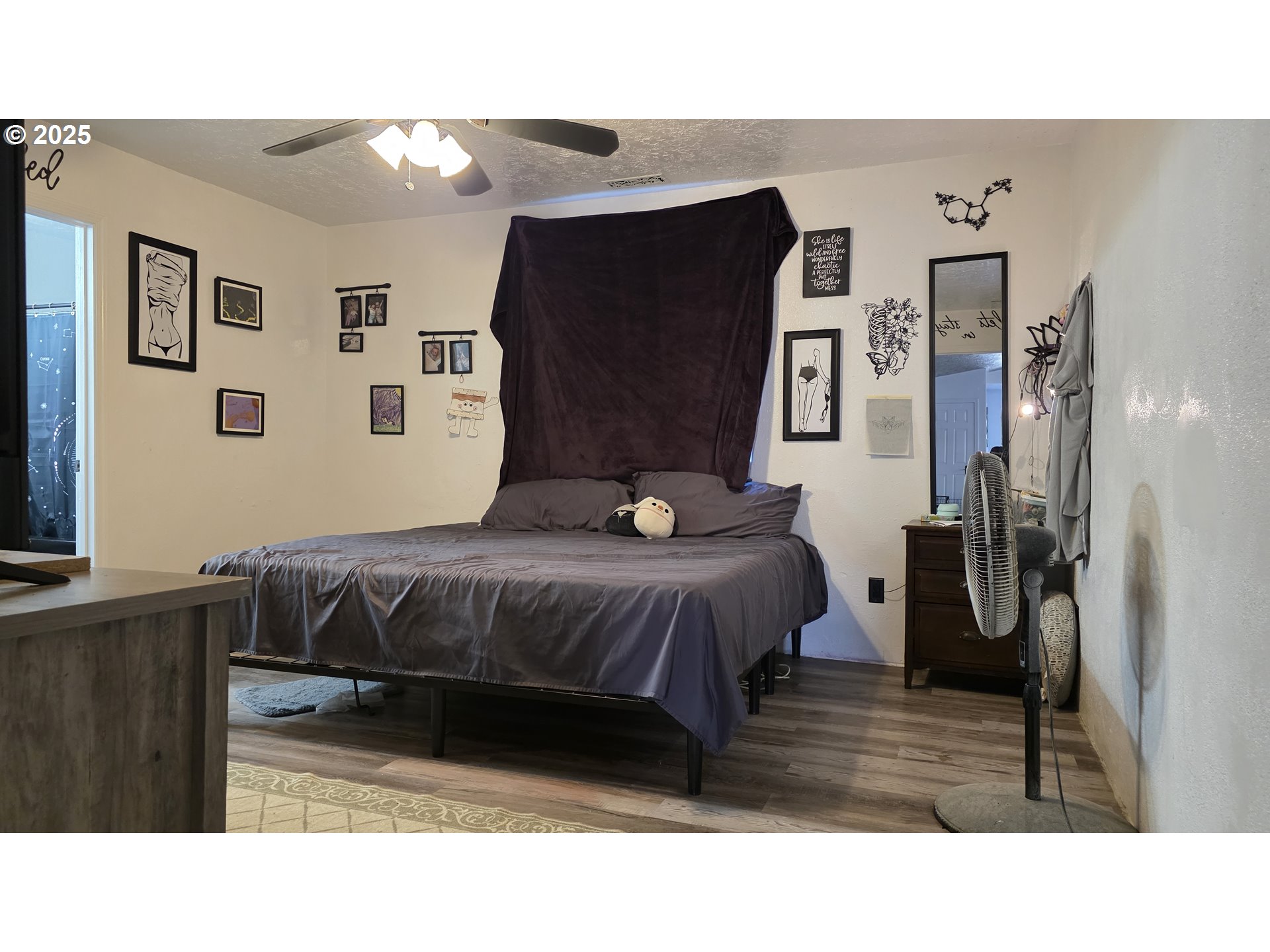 676 58th Street Springfield, OR 97478 - Photo 13 of 30 a bedroom with a bed and wooden floor