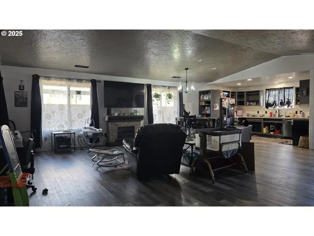 a living room with lots of furniture and kitchen view