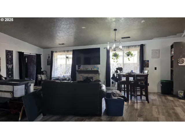 a living room with furniture a window and flat screen tv