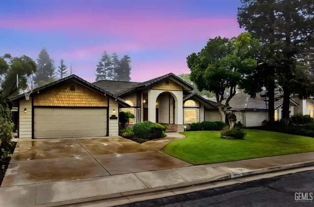 a front view of a house with a garden and plants