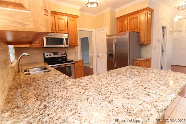a kitchen with granite countertop a sink and a window