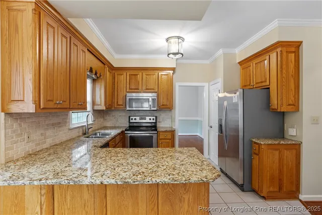 a kitchen with stainless steel appliances granite countertop wooden cabinets a refrigerator and a sink