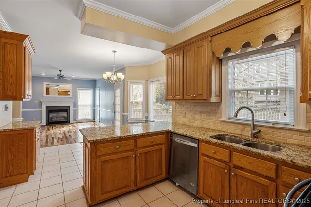 a large kitchen with kitchen island granite countertop a sink stainless steel appliances and cabinets