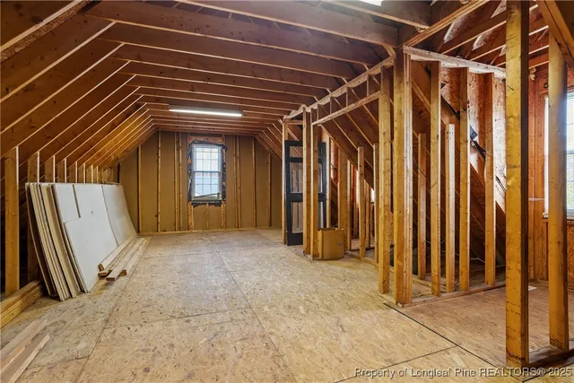 a view of a room with wooden walls and stairs