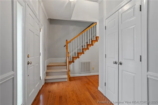 a view of entryway with wooden floor and stairs