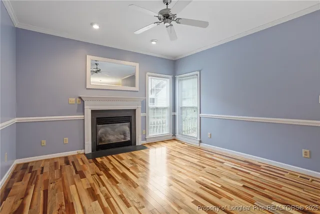 a view of an empty room with a fireplace and a window