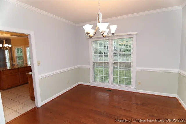 a kitchen with stainless steel appliances kitchen island granite countertop a refrigerator stove and sink