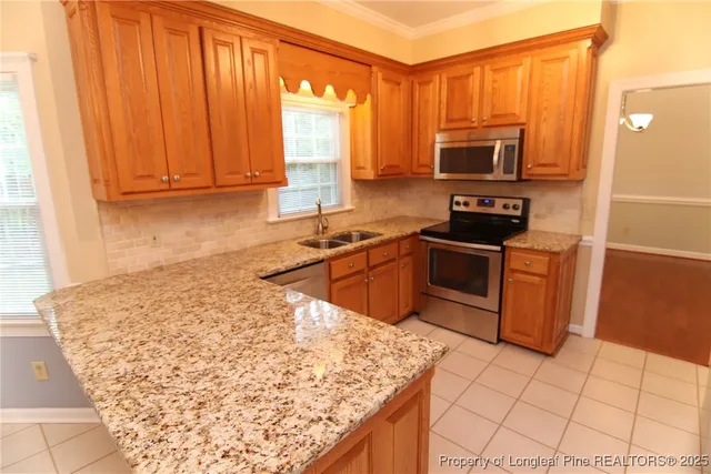 a kitchen with stainless steel appliances granite countertop a sink and a cabinets