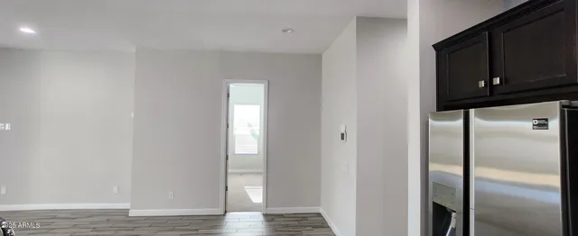 a view of a closet area with wooden floor