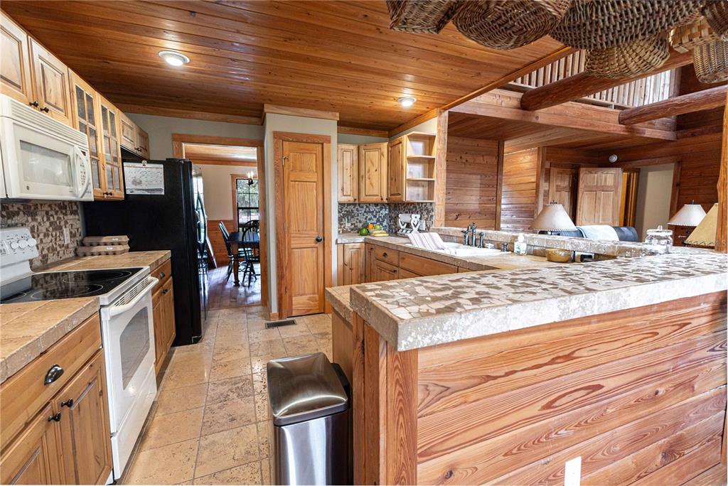 8091 County Road 476B Bushnell, FL 33513 - Photo 15 of 67 a kitchen with stainless steel appliances granite countertop sink stove and refrigerator