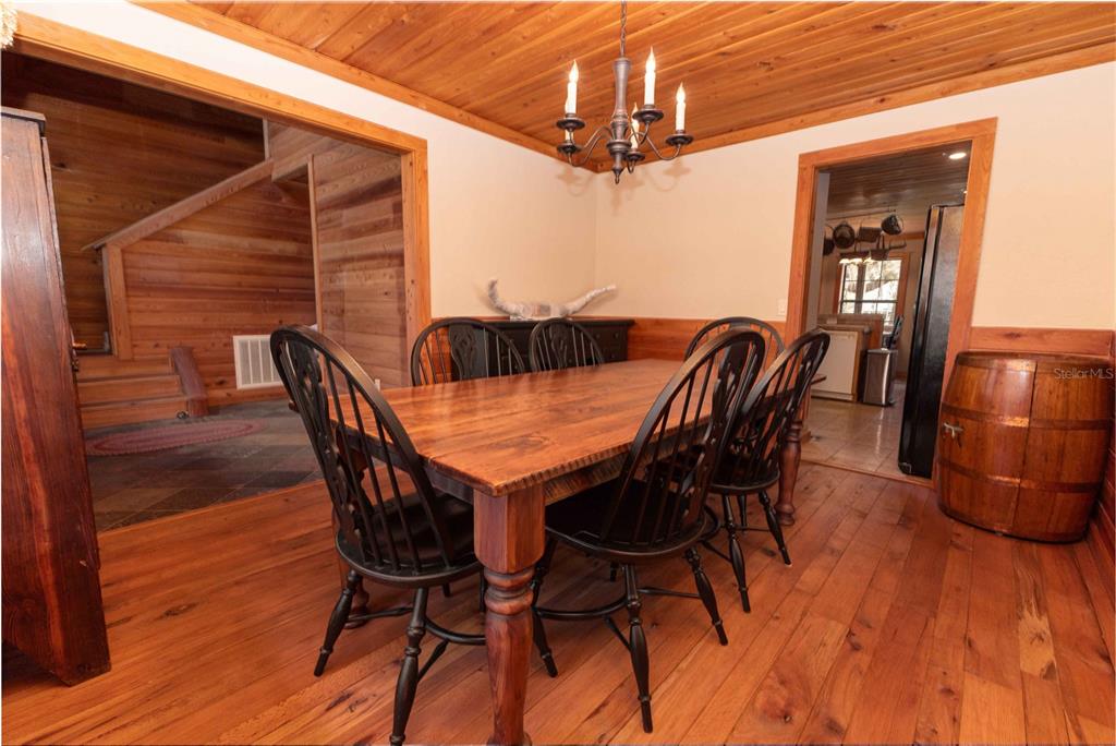 8091 County Road 476B Bushnell, FL 33513 - Photo 18 of 67 a view of a dining room with furniture and wooden floor