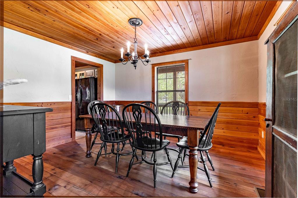 8091 County Road 476B Bushnell, FL 33513 - Photo 20 of 67 a dining room with furniture a chandelier and wooden floor