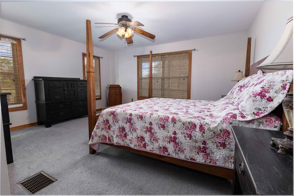 8091 County Road 476B Bushnell, FL 33513 - Photo 22 of 67 a bedroom with a bed and a chandelier