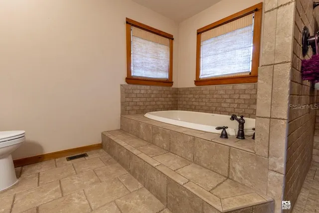 a bathroom with a bathtub and a shower