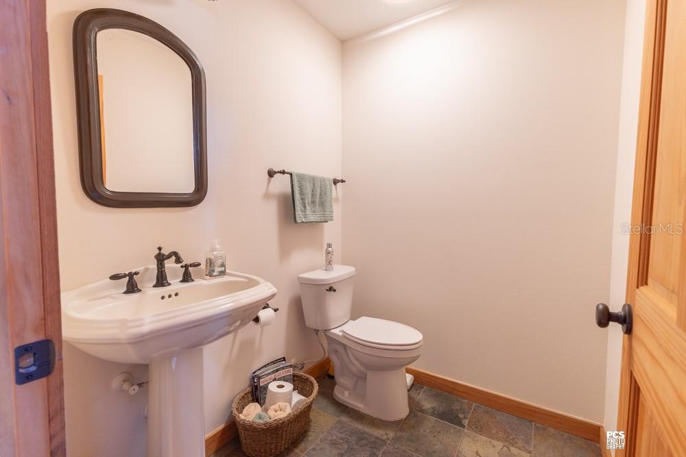8091 County Road 476B Bushnell, FL 33513 - Photo 36 of 67 a bathroom with a toilet sink and mirror