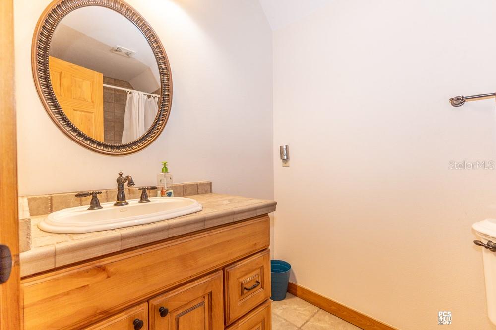 8091 County Road 476B Bushnell, FL 33513 - Photo 38 of 67 a bathroom with a sink and a mirror