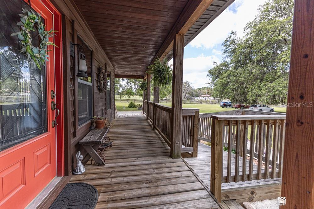 8091 County Road 476B Bushnell, FL 33513 - Photo 45 of 67 a view of a balcony with wooden floor and outdoor seating