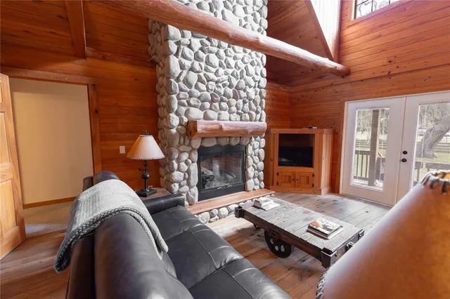 a living room with furniture a chandelier and a dining table