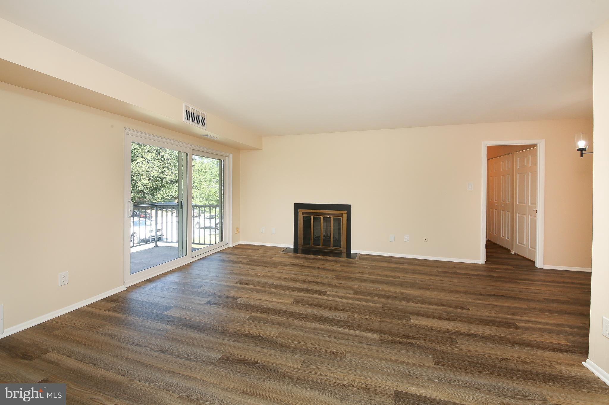 463 Old Forge Crossing, Unit 463 Devon, PA 19333 - Photo 4 of 35 Wood burning fireplace & sliders to balcony