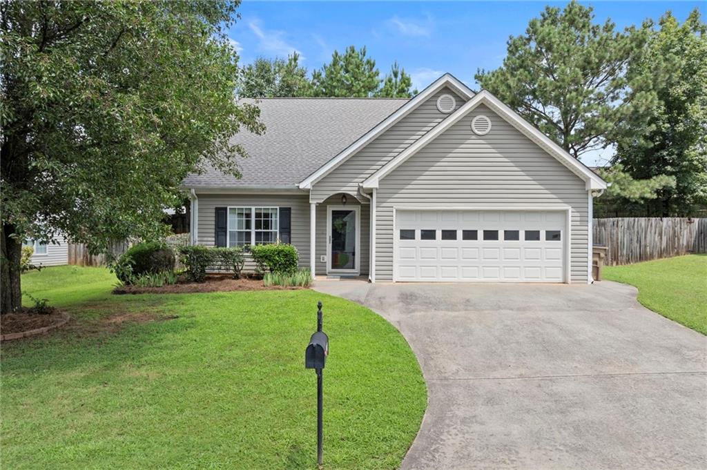 303 Apache Drive Canton, GA 30115 - Photo 1 of 1 a view of a house with a yard and a garden