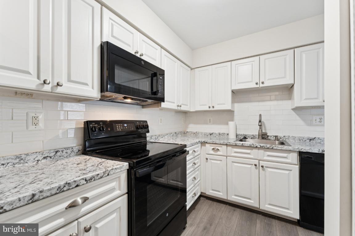 13 Ohara Court Olney, MD 20832 - Photo 13 of 25 a kitchen with cabinets appliances a sink and a counter top space