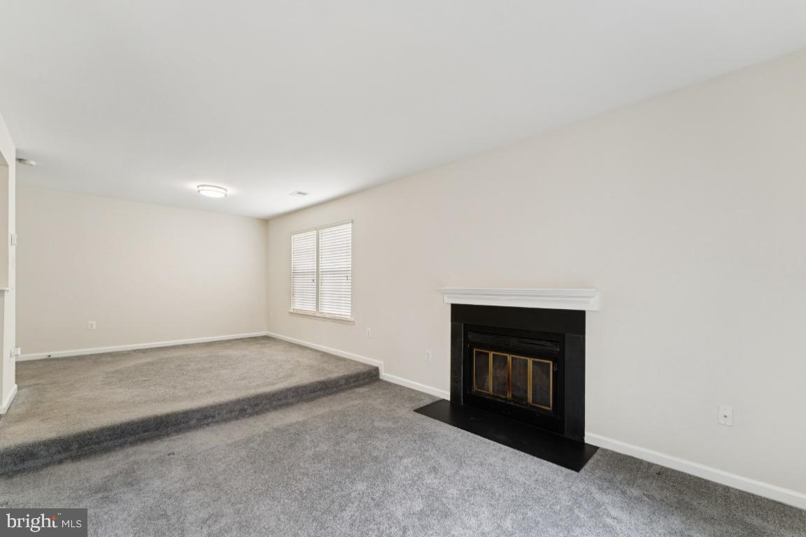 13 Ohara Court Olney, MD 20832 - Photo 5 of 25 a view of an empty room with a fireplace and a window