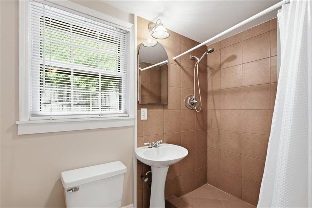 1424 Emory Road Northeast Atlanta, GA 30306 - Photo 20 of 36 a bathroom with a sink a toilet and a shower