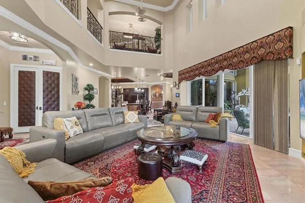 a living room with furniture and a floor to ceiling window