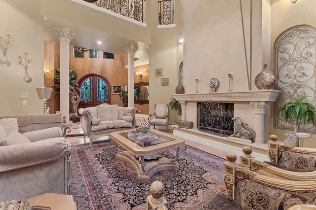 a living room with furniture a window and a chandelier